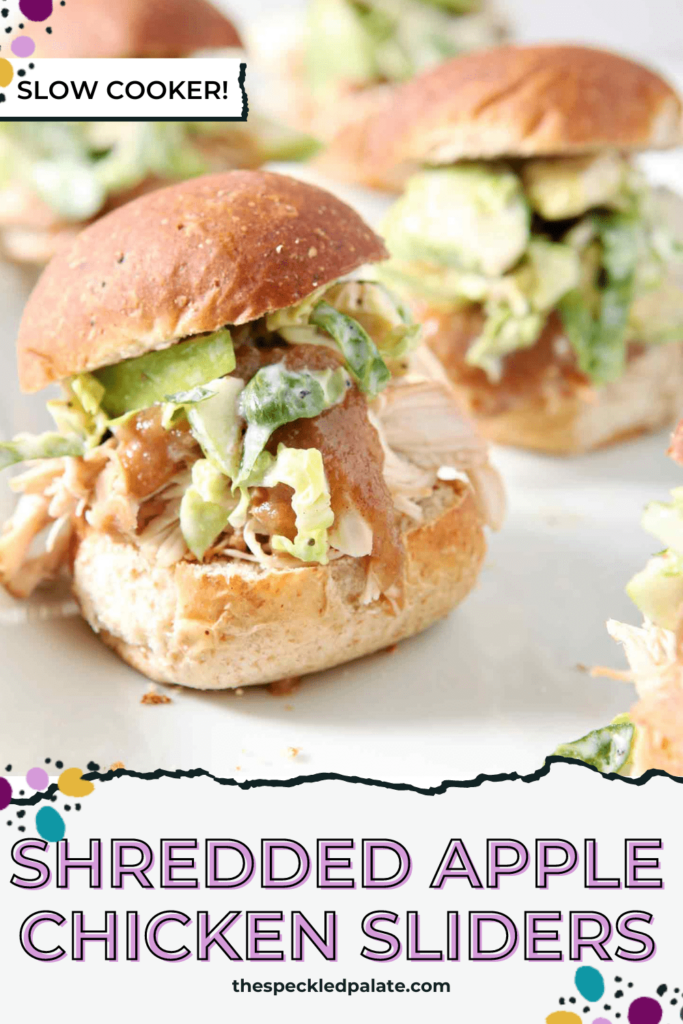 Close up of shredded chicken sliders with slaw on a white plate with the text shredded apple chicken sliders