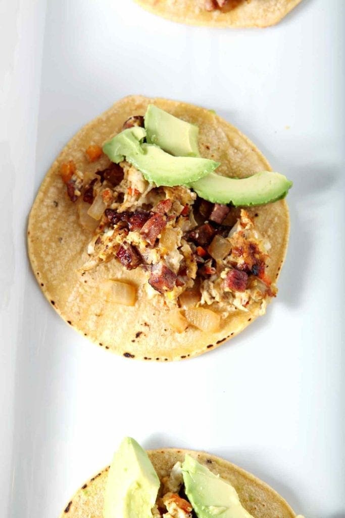 close up of an andouille breakfast taco on a white plate