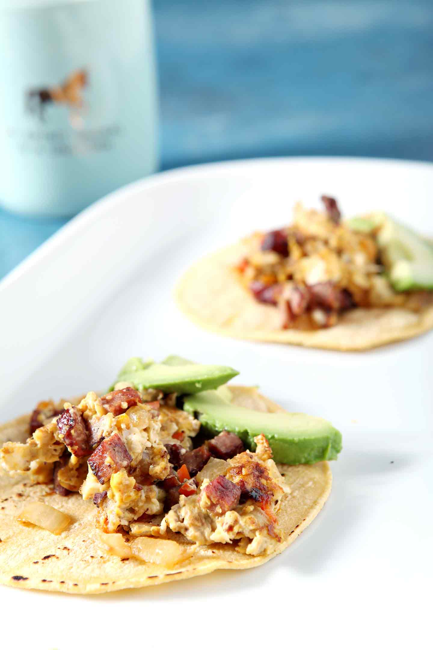 two andouille breakfast tacos on a white plate