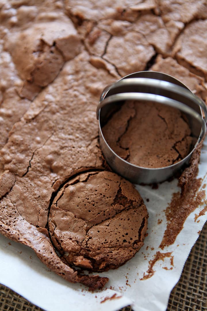 Biscuit cutter cutting into sheet of baked cake 