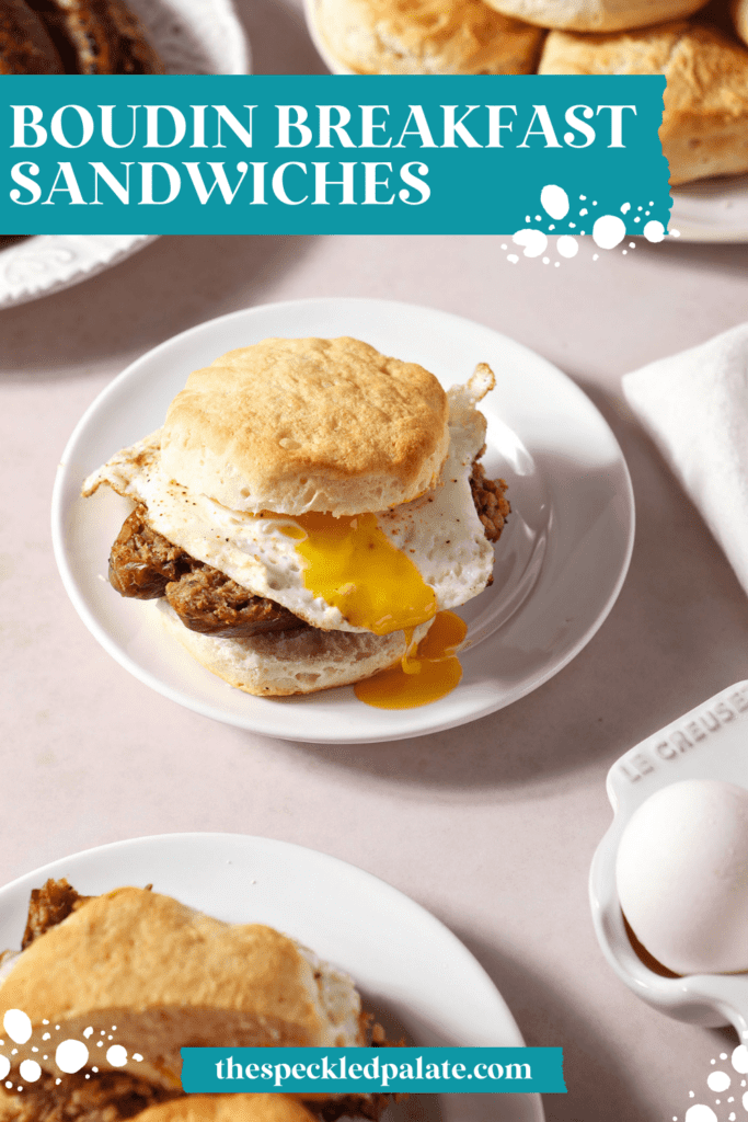 Two breakfast sandwiches on biscuits with a fried egg on white plates with the text Boudin Breakfast Sandwiches