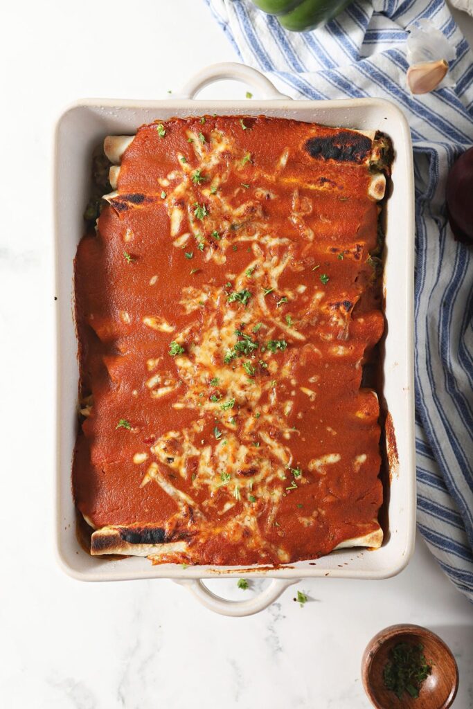 Baked zucchini enchiladas on marble before serving