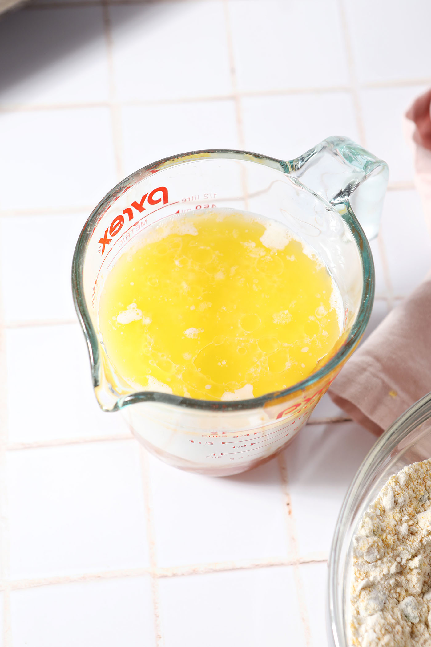 Wet ingredients in a liquid measuring cup for corn muffins