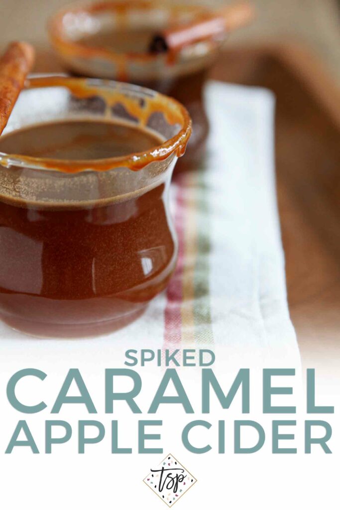 Pinterest graphic of Spiked Caramel Apple Cider, showing two glasses of the hot drink and Pinterest text