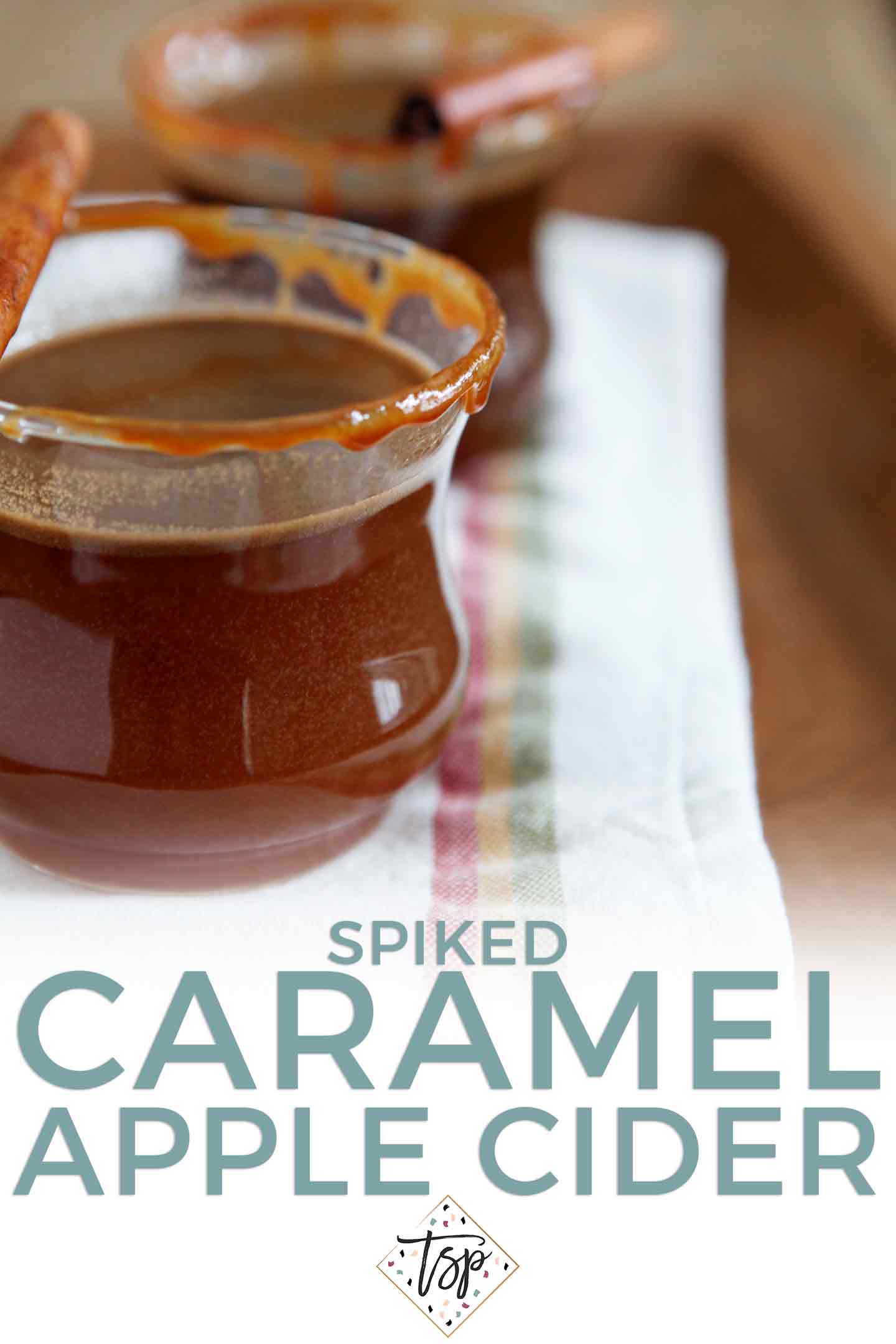 Pinterest graphic of Spiked Caramel Apple Cider, showing two glasses of the hot drink and Pinterest text