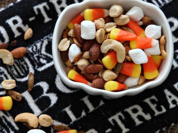 Overhead close up of Halloween Trail Mix in white pumpkin bowl