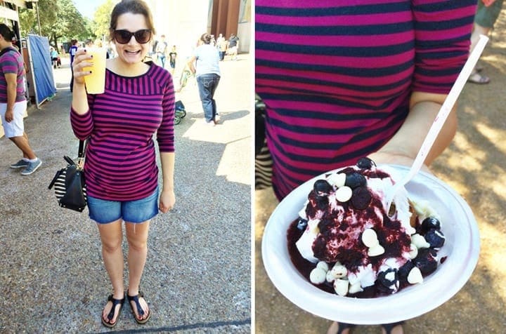 Woman holding beverage and plate of food at the fair 