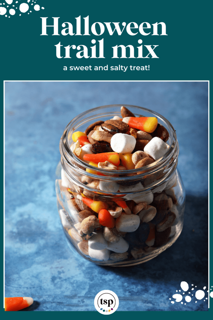 Halloween trail mix with candy corn in a mason jar on a blue background with the text halloween trail mix a sweet and salty treat