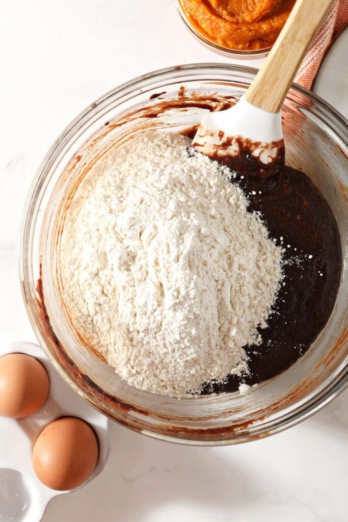 Add the dry ingredients to the brownie base mix in a bowl