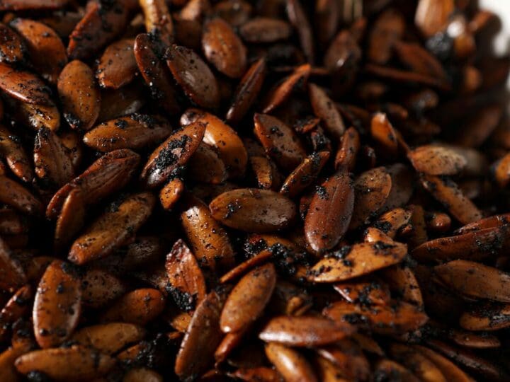 Close up of roasted pepitas in a white bowl