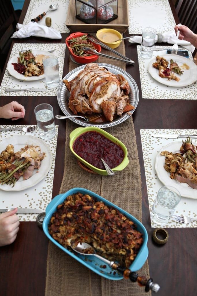 A Friendsgiving table lined with dishes before guests begin eating