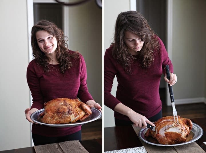 A women holds and slices turducken from serving platter 