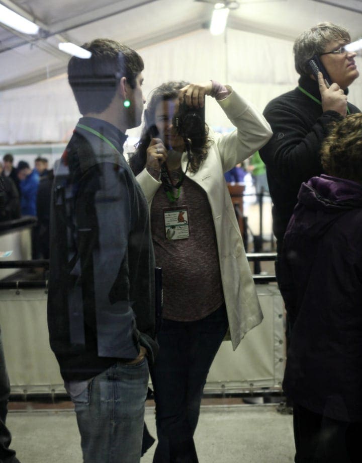 Woman holding black camera over her eye 