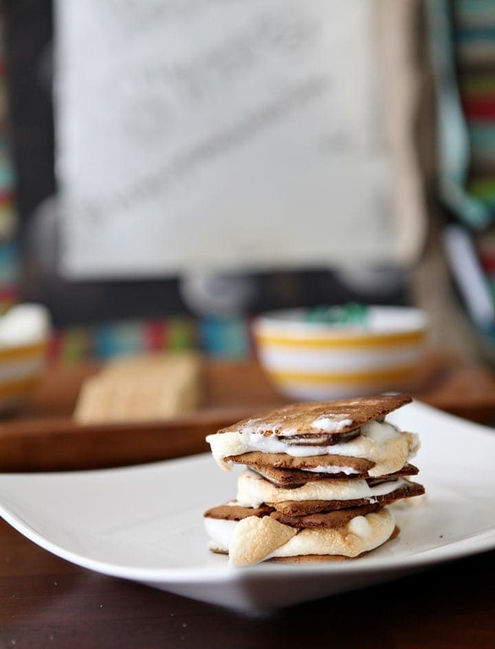 Stack of toasted s'mores on white dish 