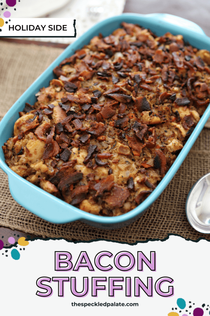 A blue casserole dish holds baked bacon baguette stuffing on a tablescape with the text bacon stuffing