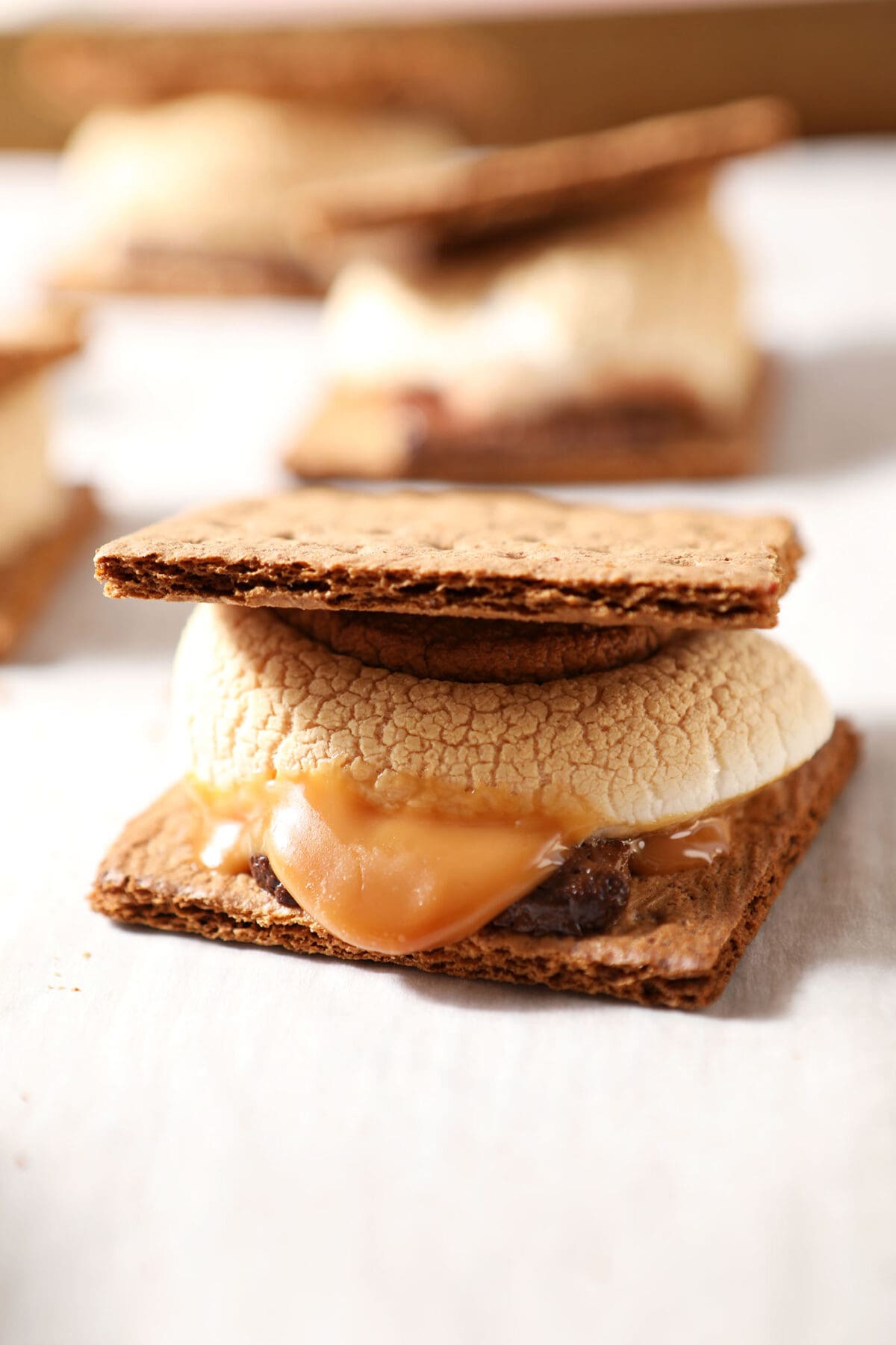Close up of a baked s’more with caramel on a sheet pan