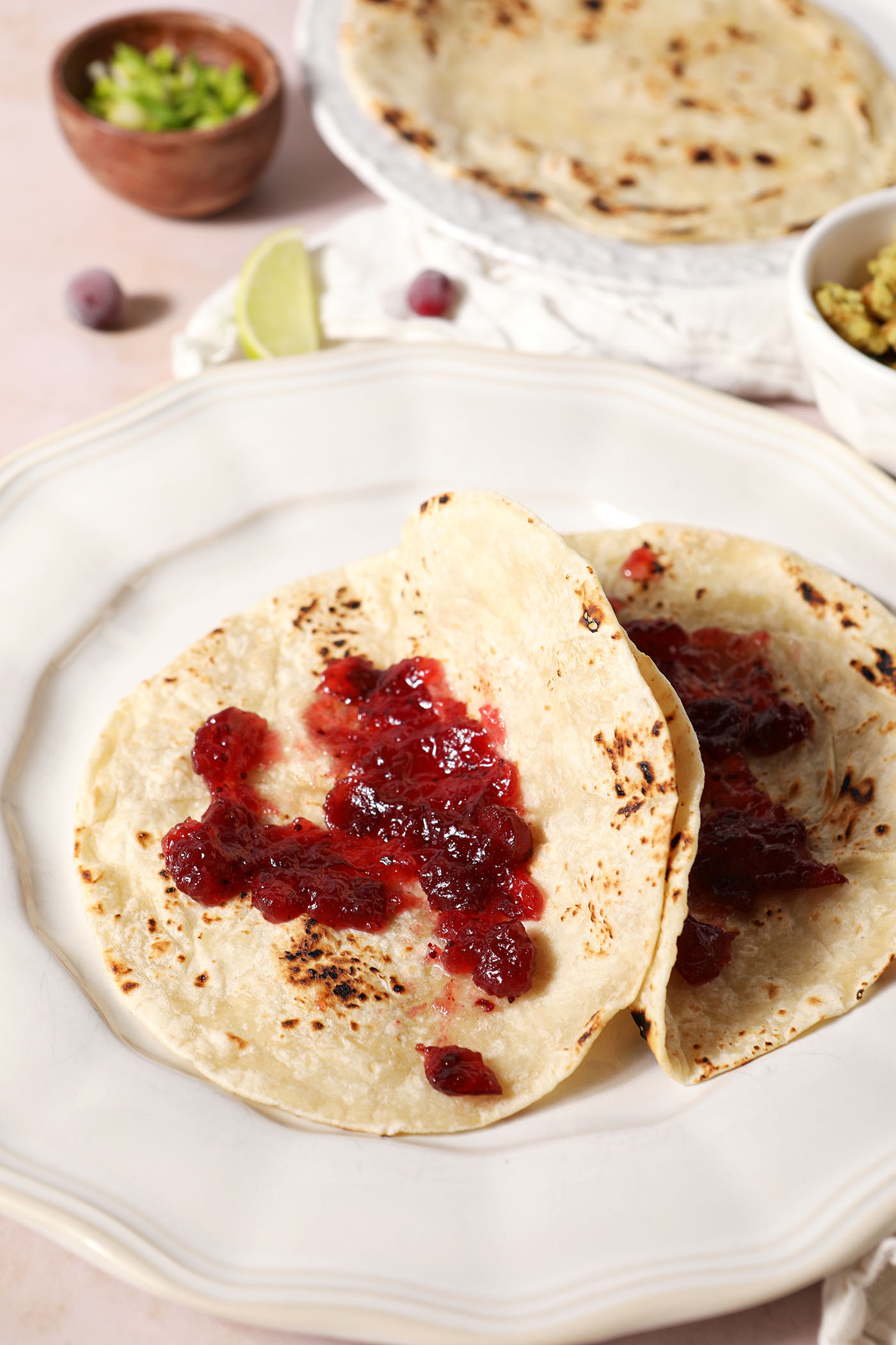Cranberry sauce smeared on flour tortillas on a white plate