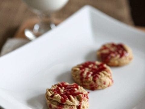 A peanut butter and jelly twist on traditional shortbread cookies for the holidays! Peanut butter shortbread is topped with a tart glaze to make these Peanut Butter Shortbread Cookies with Raspberry-Orange Glaze.