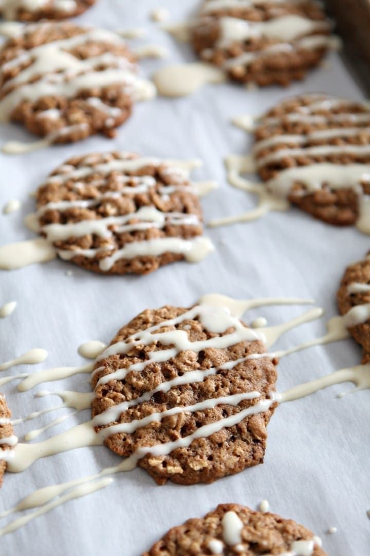 Close up of cream cheese glaze drizzled on top of Oatmeal Cinnamon cookies