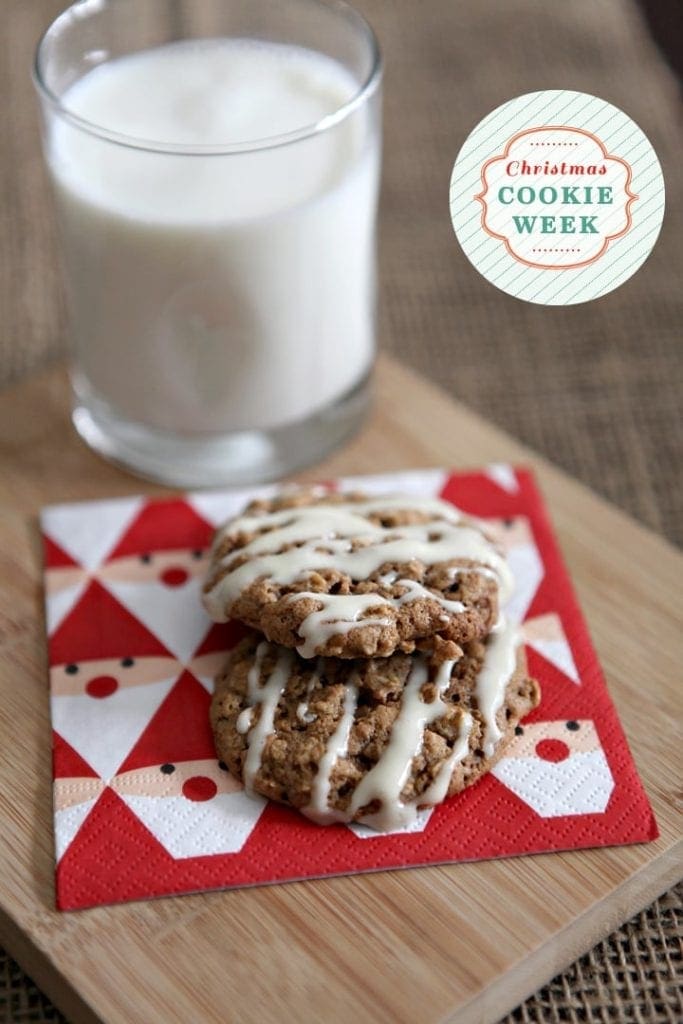 Two cookies on top of Santa napkin with glass of milk