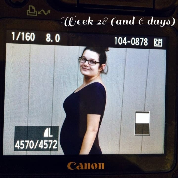 A view from the camera screen of women standing sideways 