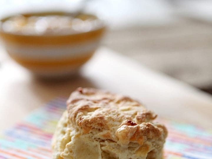 A cheddar biscuit on a rainbow napkin