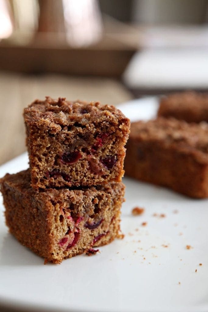 Close up of cranberry walnut bread sliced and stacked on top of each other 