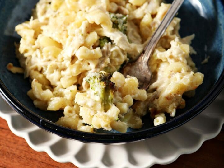 A bowl of Chicken Broccoli Macaroni and Cheese with a fork in it