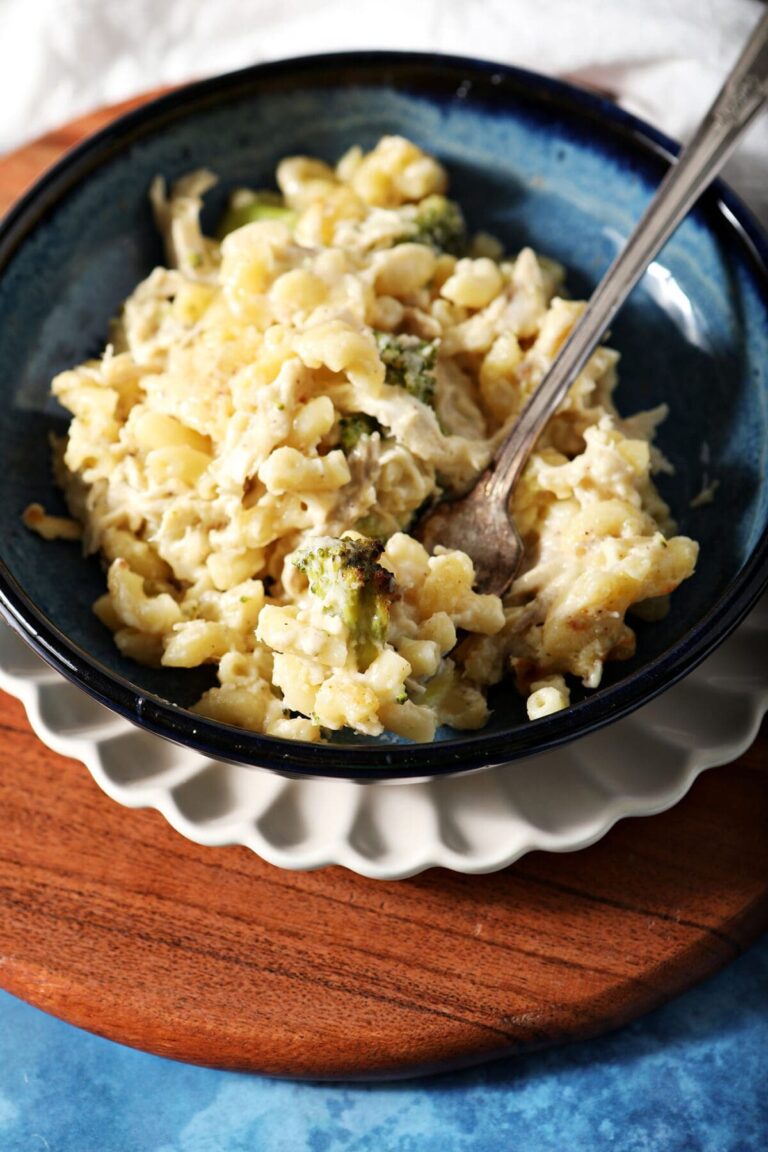 A bowl of Chicken Broccoli Macaroni and Cheese with a fork in it