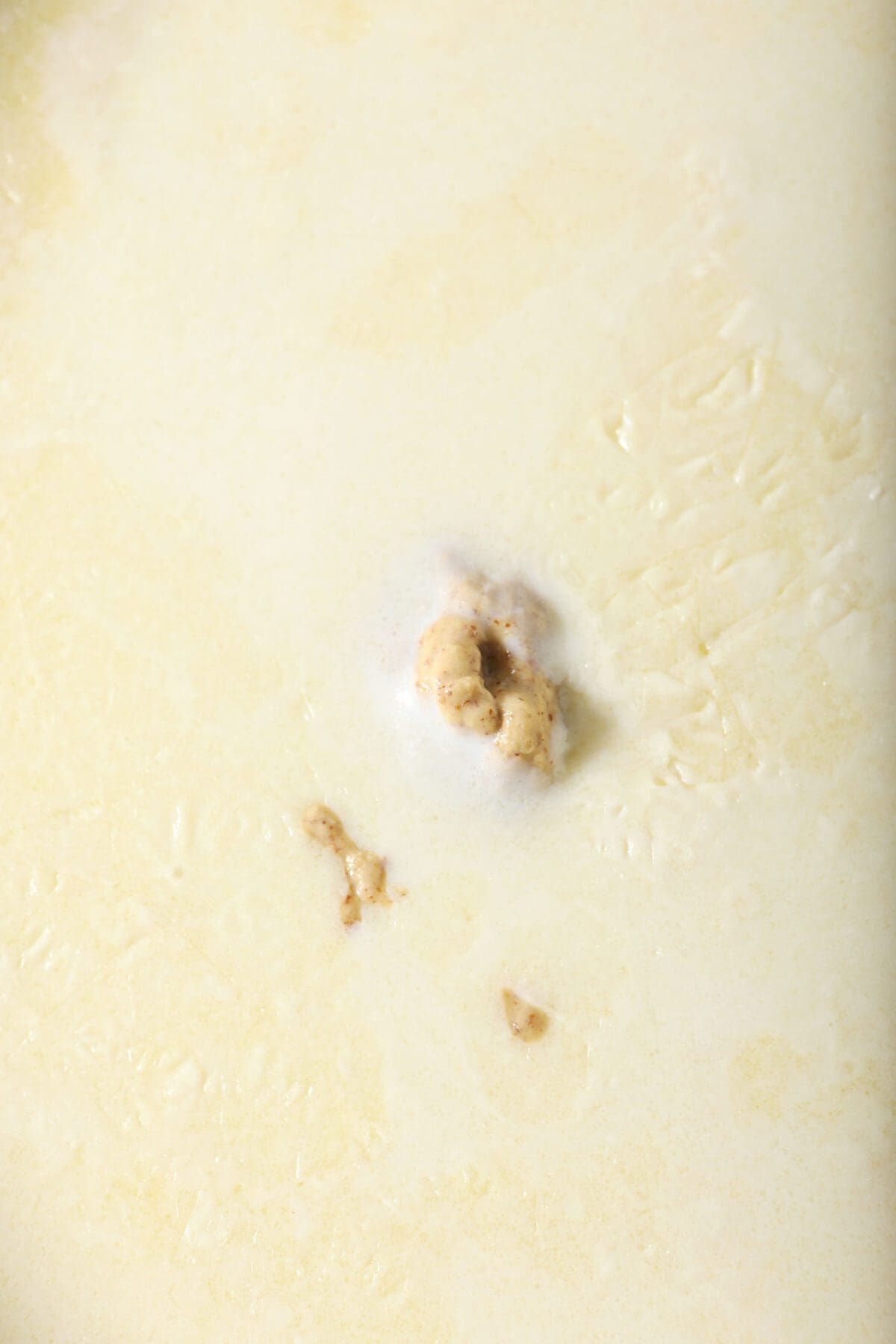 Mustard and milk are added to a roux for macaroni and cheese