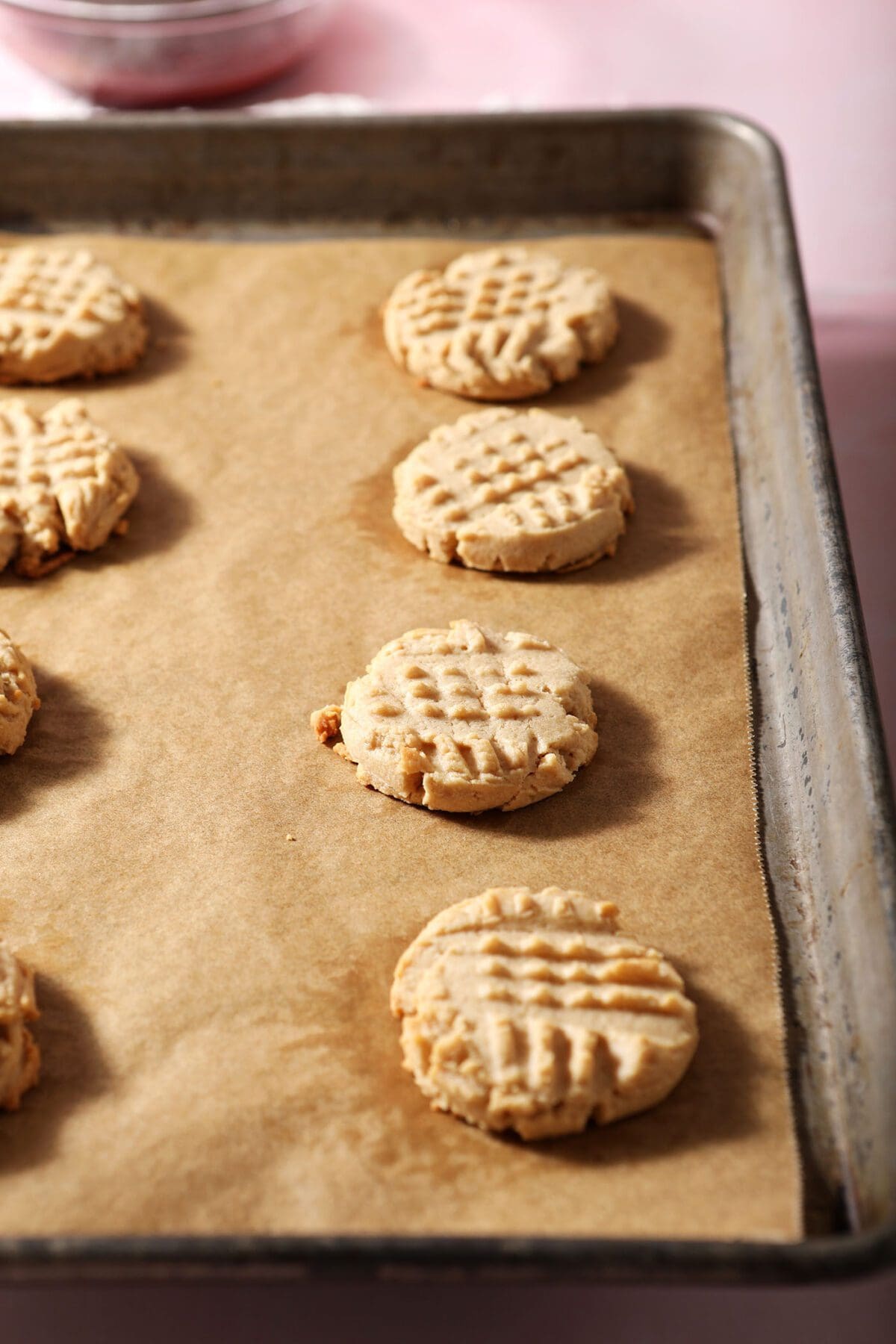 Peanut butter shortbread cookies on a sheet pan after baking