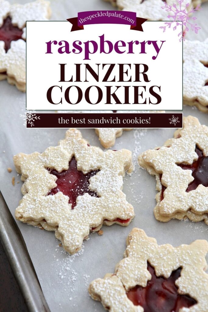 Snowflake-shaped raspberry liner cookies on a baking sheet with the text raspberry linzer cookies the best sandwich cookies