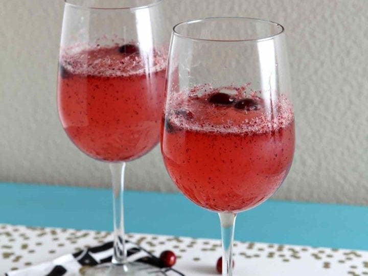 Two glasses of sparkling cranberry mocktails on new year's eve glasses