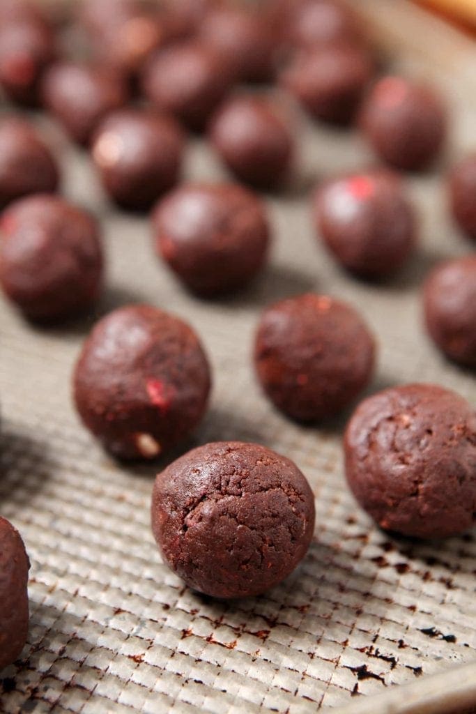 A close up of brownie balls on sheet 