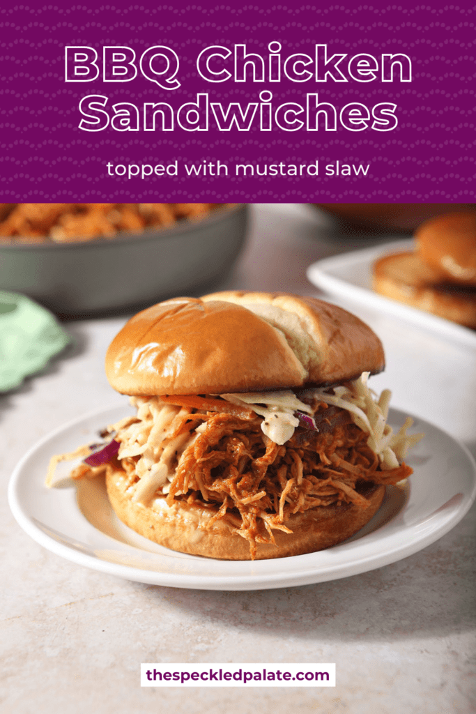 A BBQ chicken sandwich on a plate topped with coleslaw with the text BBQ Chicken sandwiches topped with mustard slaw