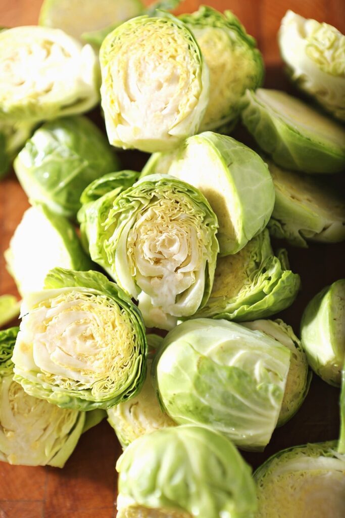 Halved brussels sprouts on a cutting board