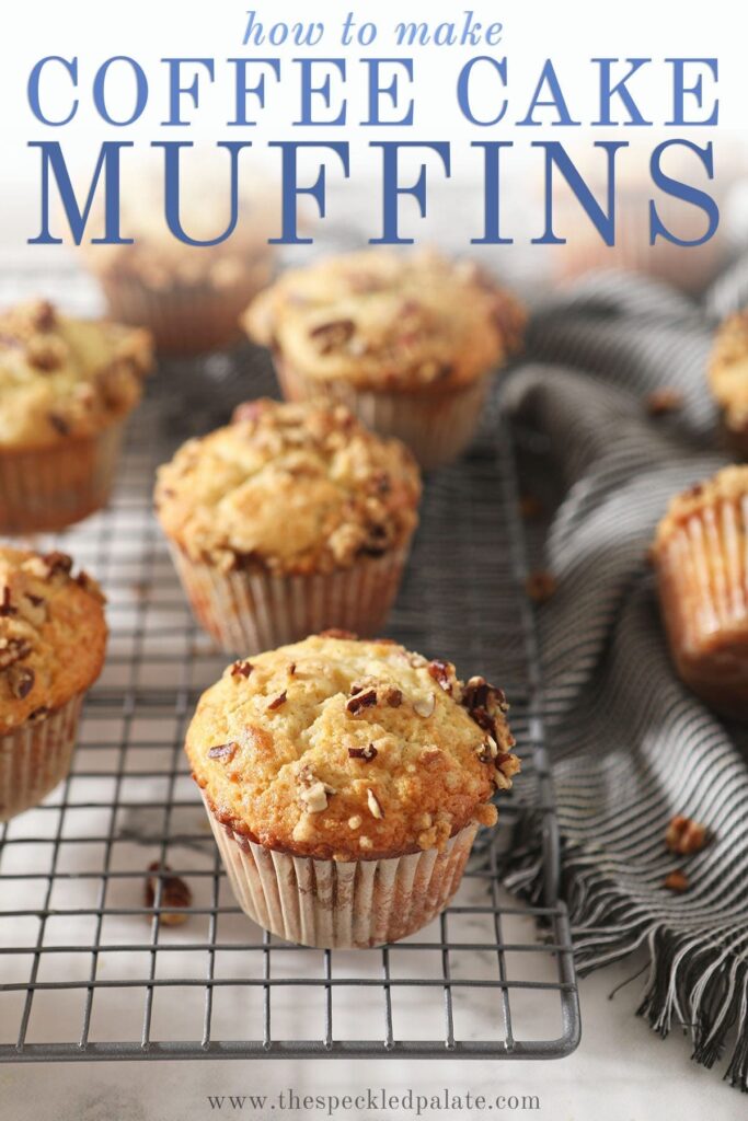 Coffee Cake Muffins sit on a wire cooling rack next to a gray striped towel with the text 'how to make coffee cake muffins'