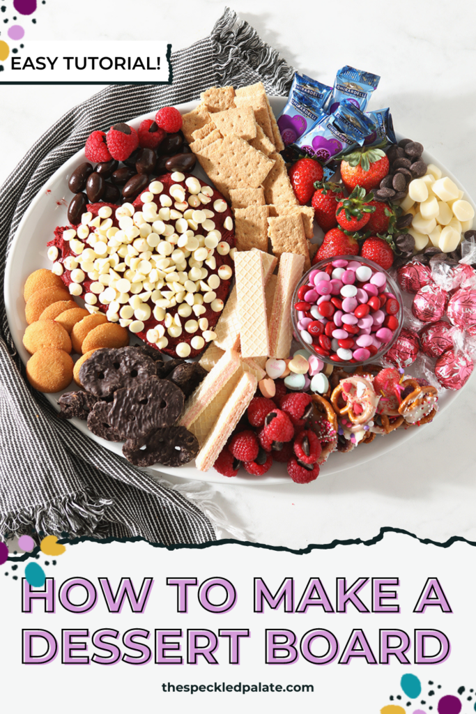 Close up of a dessert board with a heart-shaped dip with the text How to make a Dessert Board