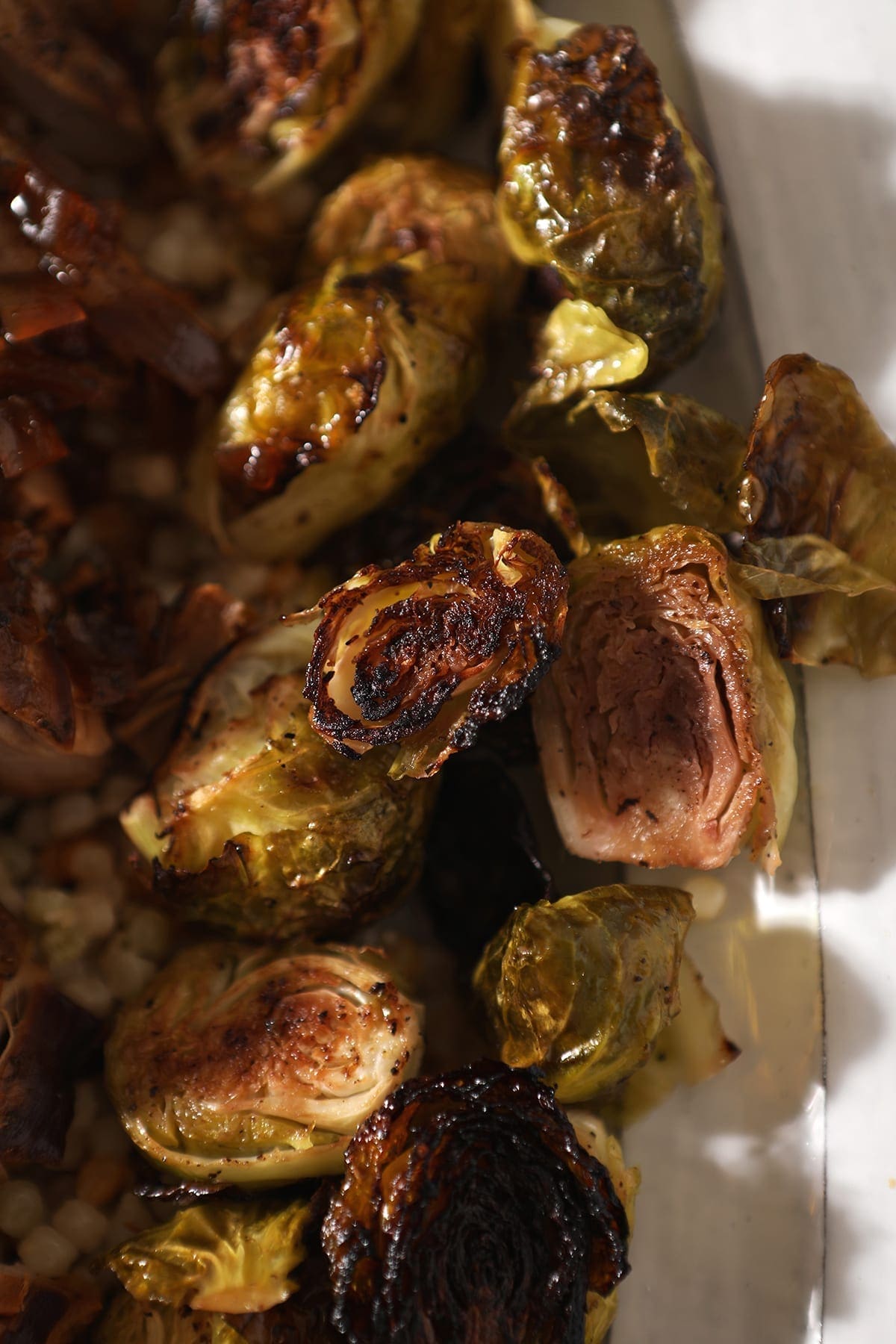 Roasted brussels sprouts on a white serving tray