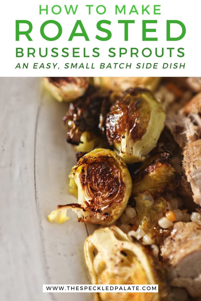 Close up of roasted brussels sprouts on a white serving tray with meat and couscous with the text 'how to make roasted brussels sprouts, an easy, small batch side dish'