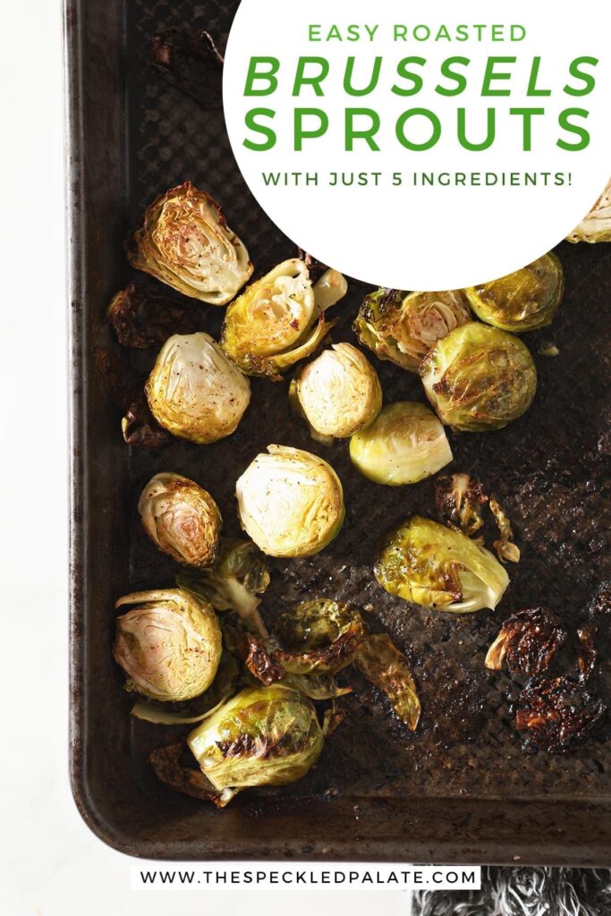 Brussels sprouts on a baking sheet after baking with the text 'easy roasted brussels sprouts with just 5 ingredients'