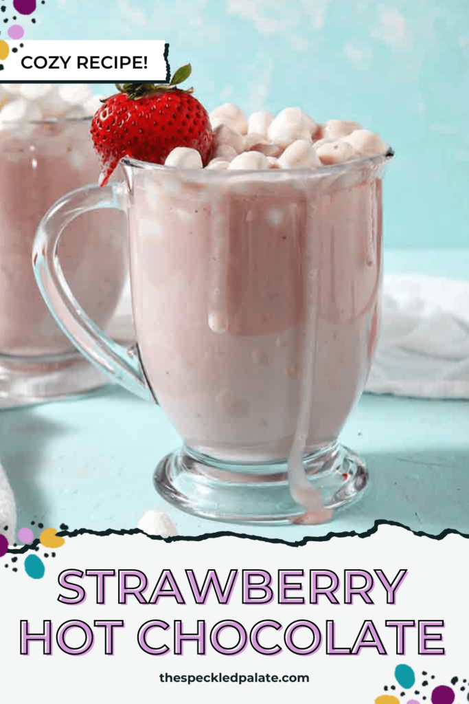 Two mugs hold a pink hot chocolate garnished with marshmallows and strawberries with the text Strawberry Hot Chocolate