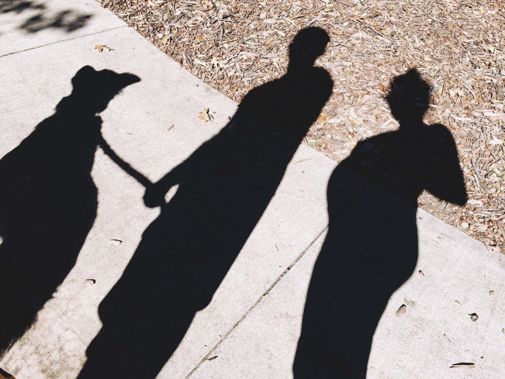 Shadows of two people and a dog 