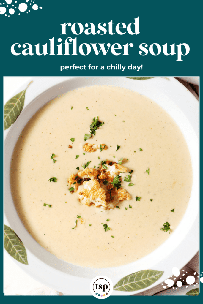 Close up of a bowl of roasted cauliflower cheese soup from above garnished with cauliflower and chopped parsley with the text roasted cauliflower soup perfect for a chilly day