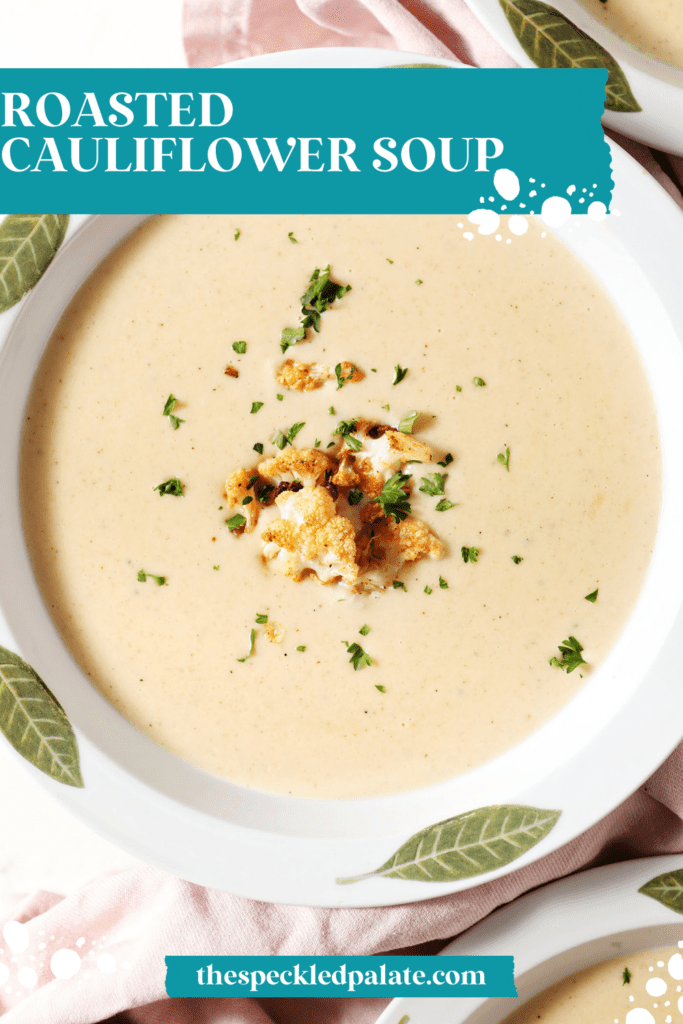 Close up of a bowl of cauliflower cheese soup from above garnished with cauliflower and chopped parsley with the text roasted cauliflower soup