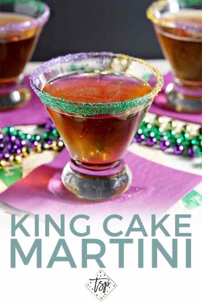 A dessert martini on a purple napkin, surrounded by festive mardi gras beads with the text 'king cake martini'