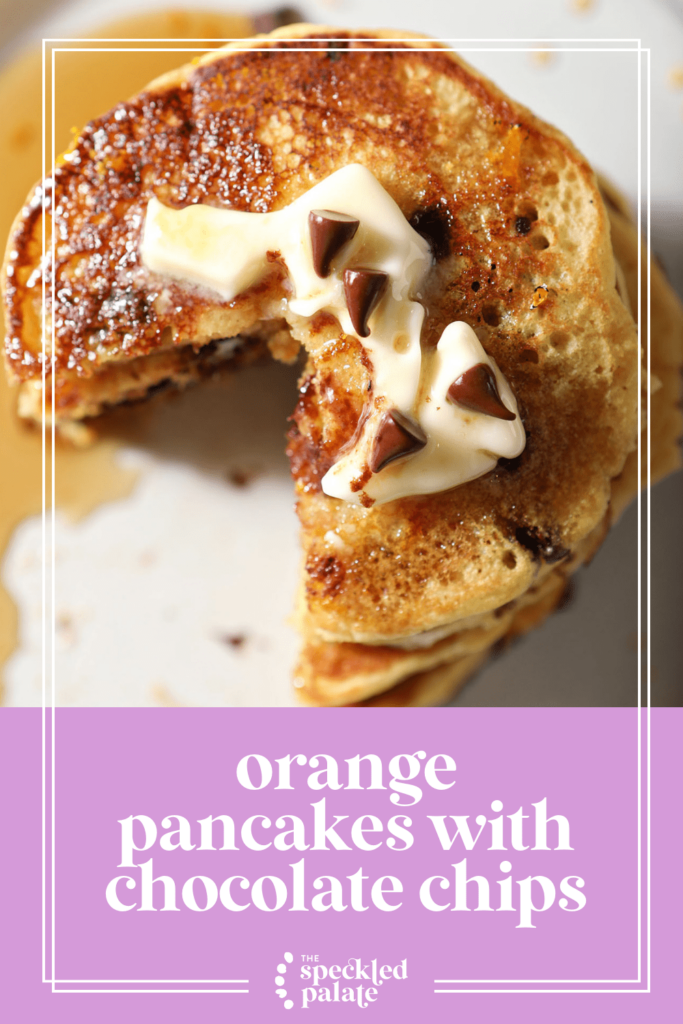 A sliced-into stack of pancakes with syrup, butter and mini chocolate chips as garnish with the text orange pancakes with chocolate chips