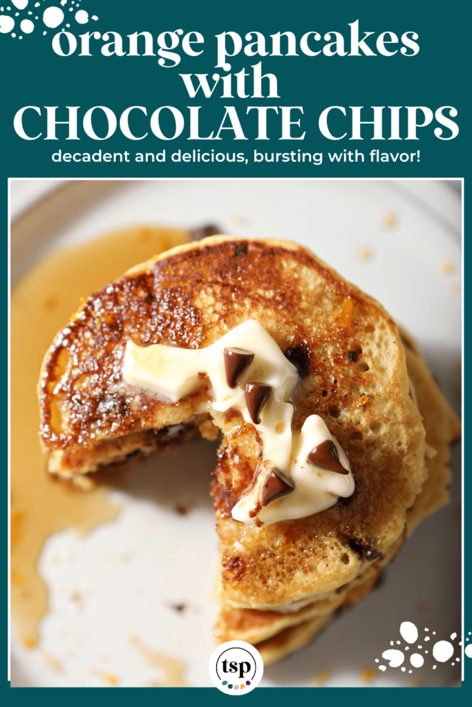 A sliced-into stack of pancakes with syrup, butter and mini chocolate chips as garnish with the text orange pancakes with chocolate chips decadent and delicious, bursting with flavor