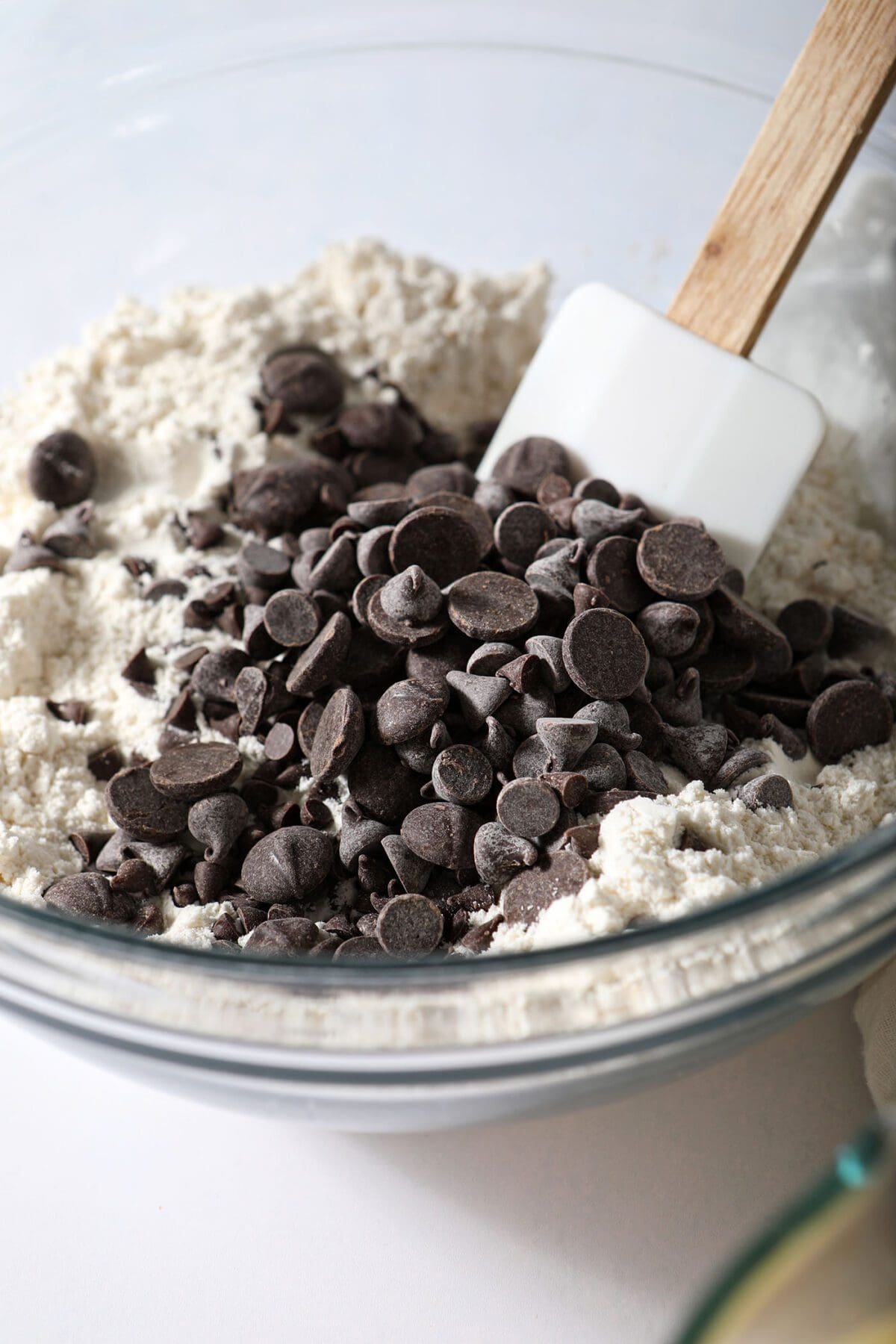 Chocolate chips are stirred into dry ingredients