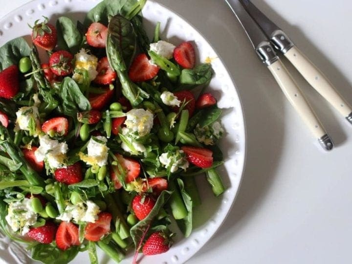 Overhead view of Spring Pea, Asparagus and Strawberry Salad in white bowl  